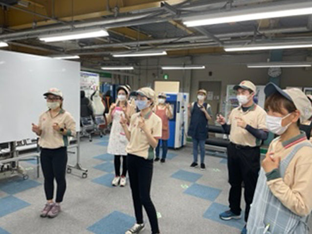Original sign language to facilitate communication with hearing-impaired company members